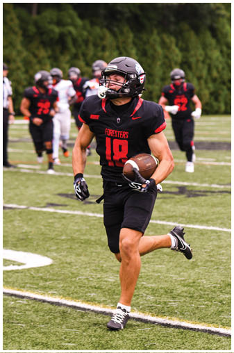 A football player running on the field. Description generated by AI