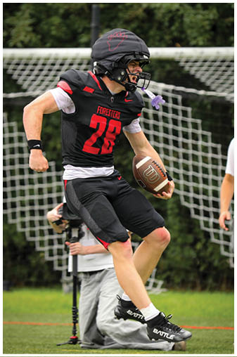 A football player wearing a black jersey with the number 28 on it. Description generated by AI