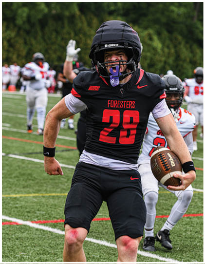 A football player wearing a black helmet and jersey with the number 25. Description generated by AI