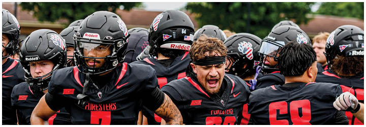 A group of football players wearing black jerseys with the number 7. Description generated by AI