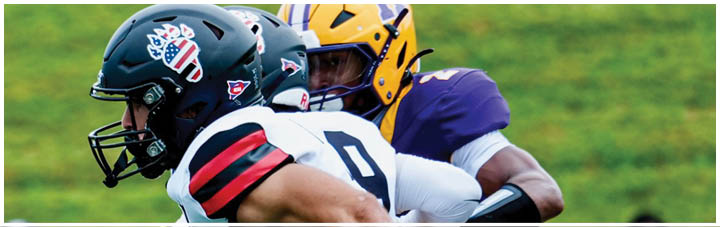 A football player in a white jersey with the number 11 on it is running with a football. Description generated by AI
