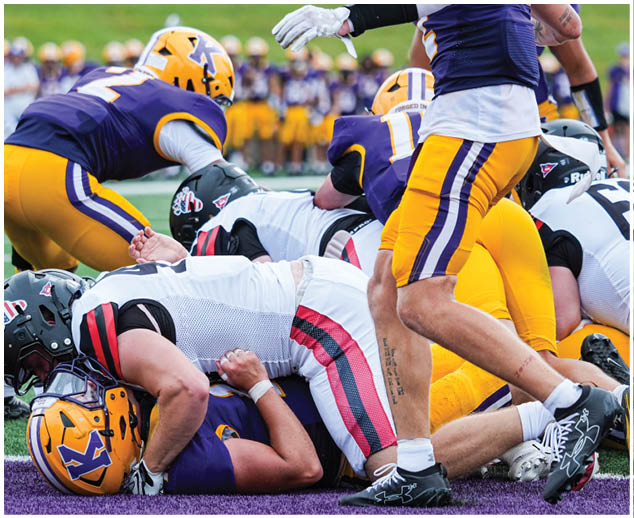 A group of football players on a field. Description generated by AI