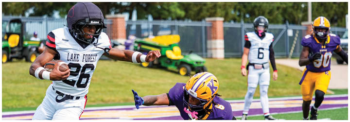 A football player running with a football. Description generated by AI