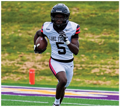 A football player running on a field. Description generated by AI