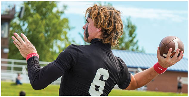 A man wearing a football jersey with the number 6 on it. Description generated by AI