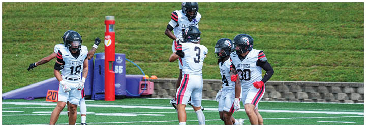 A group of football players on a field. Description generated by AI