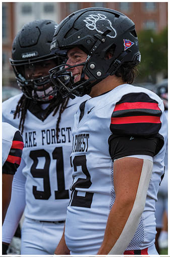 A football player wearing a helmet with the number 26 on it. Description generated by AI