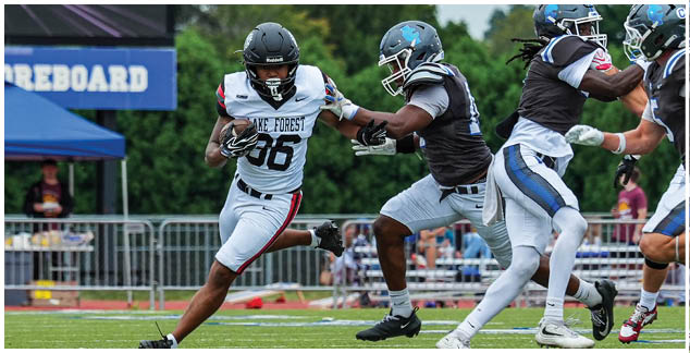 A group of football players wearing white and black uniforms. Description generated by AI