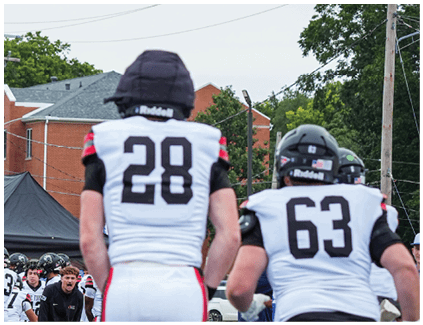 A man wearing a football helmet with the number 80 on it. Description generated by AI
