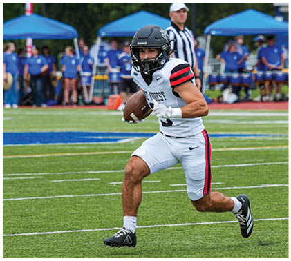Two football players on a field. Description generated by AI