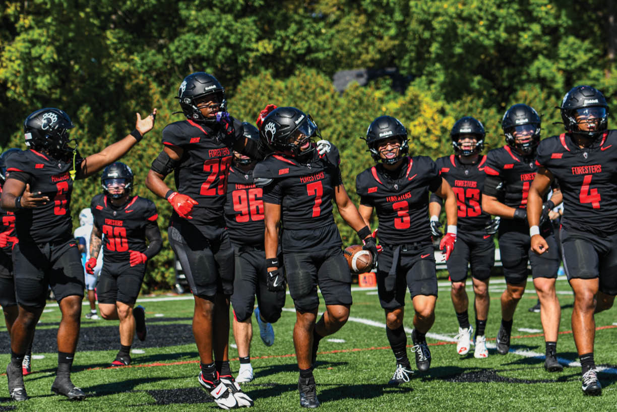 A group of people wearing black and white uniforms. Description generated by AI
