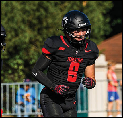 Two football players wearing black jerseys with the number 11 on them. Description generated by AI
