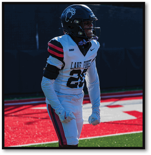 A football player wearing a black jersey with the number 6 on it. Description generated by AI