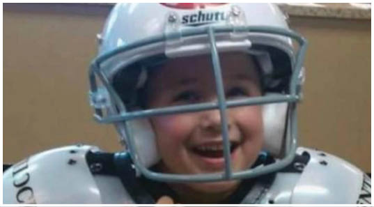 A football player wearing a blue and red jersey. Description generated by AI