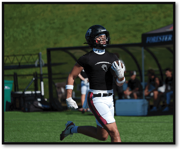 A group of football players wearing black jerseys with the number 3 on them. Description generated by AI