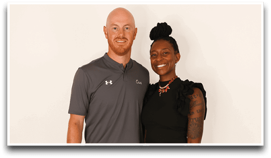 Three adults wearing football jerseys with the number 3 pose smiling against a dark background, with one holding a football. Description generated by AI