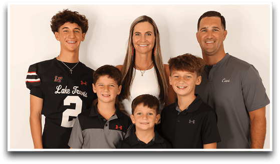 Three adults wearing football jerseys with the number 3 pose smiling against a dark background, with one holding a football. Description generated by AI