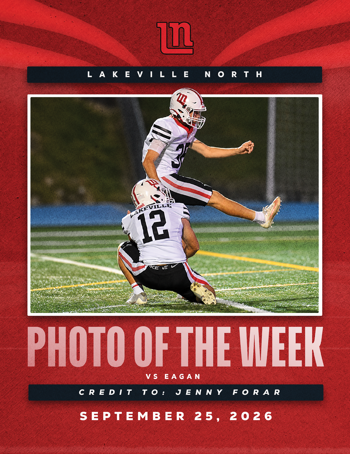 Two football players in white uniforms with red and black stripes are on a field, with one player holding the ball while the other kneels to assist, framed by a red background with text indicating this is the Lakeville North photo of the week for a game against Eagan on September 25, 2026. Description generated by AI
