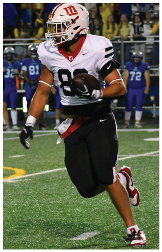 A person wearing a white and black football uniform with the number 88 is running on a football field while holding a football. Description generated by AI