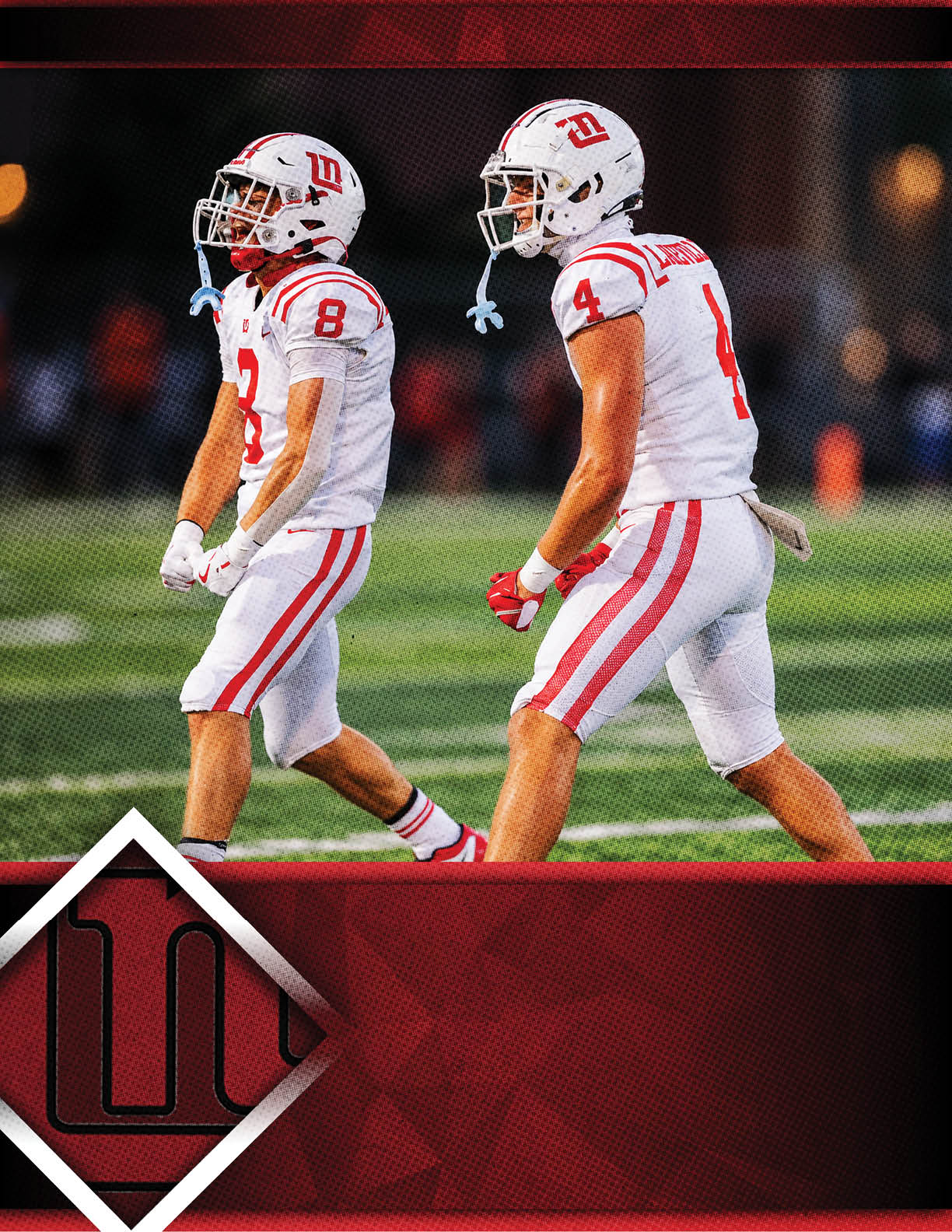 Two people in white and red football uniforms and helmets walk side by side on a green field during a game. Description generated by AI