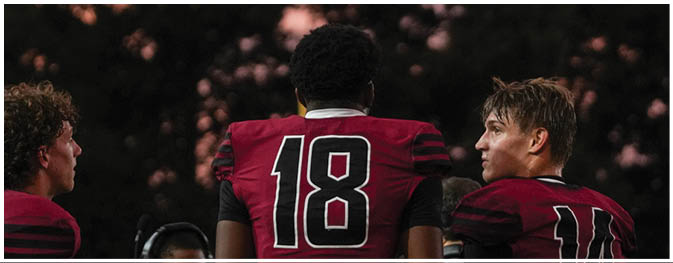 A group of football players on a field. Description generated by AI