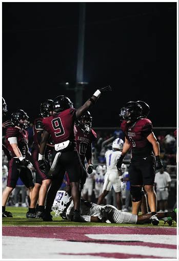 A group of football players celebrating a touchdown. Description generated by AI