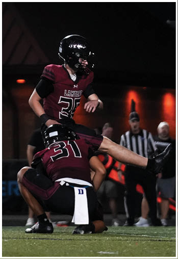 A group of football players celebrating a touchdown. Description generated by AI