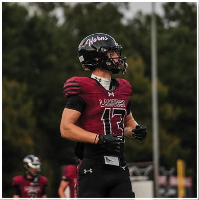 A football player running on the field. Description generated by AI