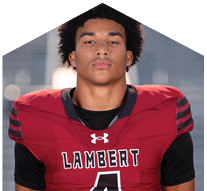 A young man wearing a white jersey with the number 10 on it. Description generated by AI