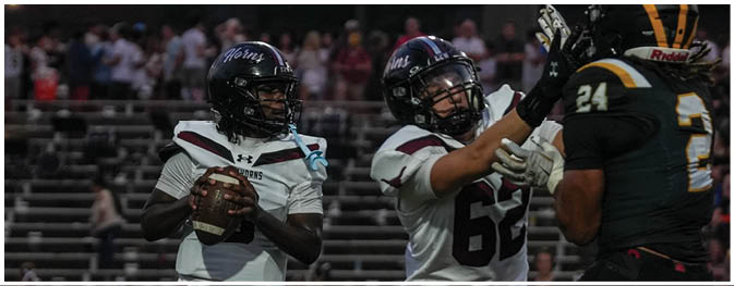 A group of football players on a field. Description generated by AI