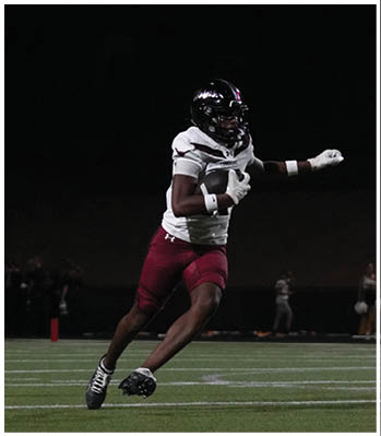 A group of football players celebrating a touchdown. Description generated by AI