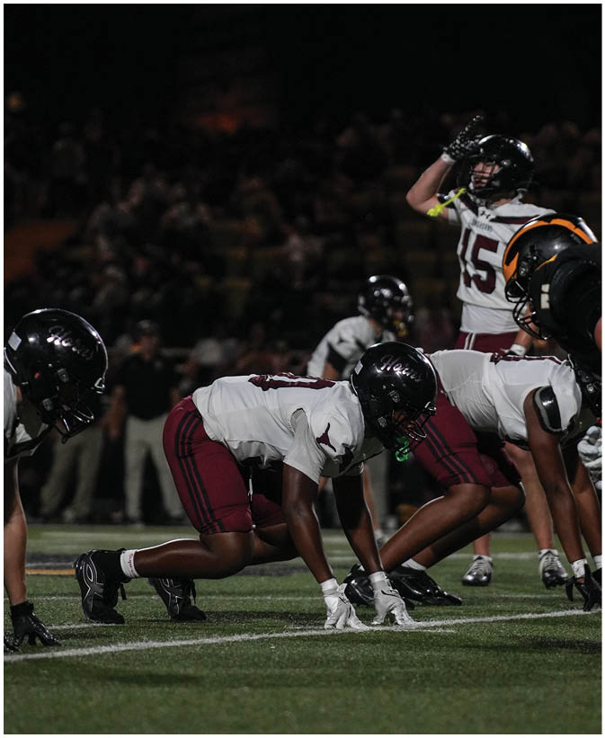 A group of football players on a field. Description generated by AI