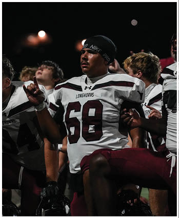 A group of football players celebrating a touchdown. Description generated by AI