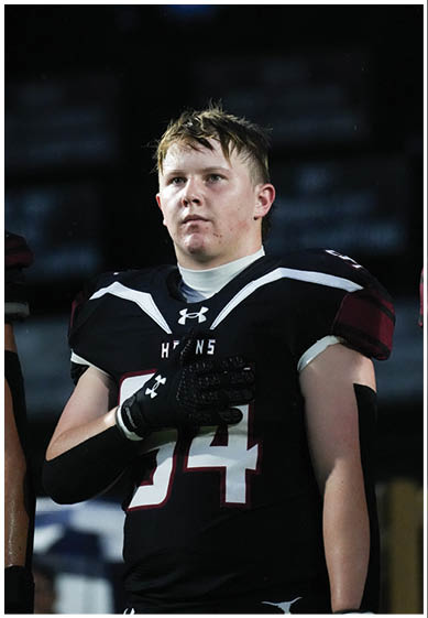 A football player wearing a blue jersey with the number 58 on it. Description generated by AI