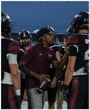 A group of football players celebrating a touchdown. Description generated by AI