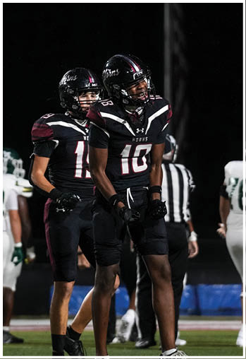 A group of football players celebrating a touchdown. Description generated by AI