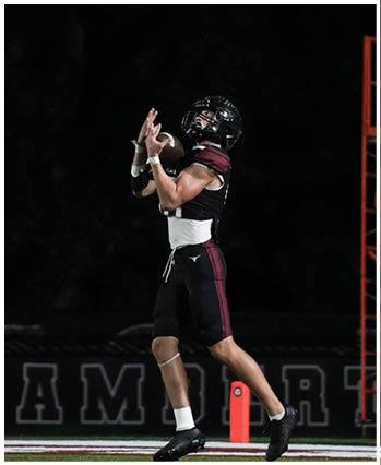 A group of football players celebrating a touchdown. Description generated by AI