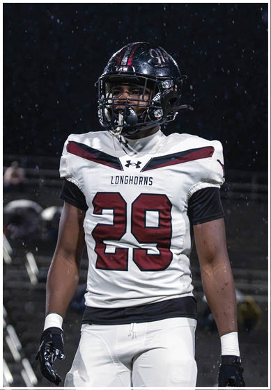 A football player wearing a blue jersey with the number 58 on it. Description generated by AI