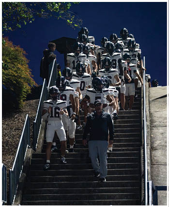A group of football players celebrating a touchdown. Description generated by AI