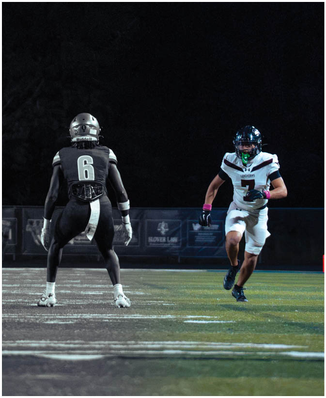 A group of football players on a field. Description generated by AI