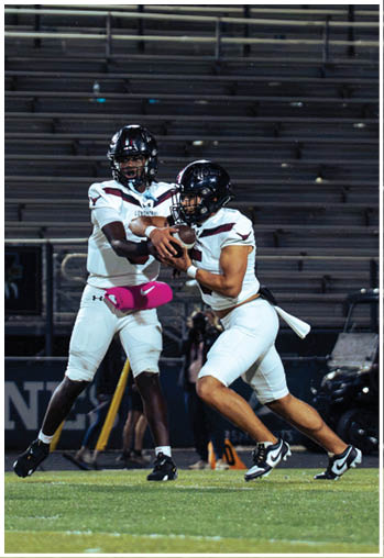 A group of football players celebrating a touchdown. Description generated by AI