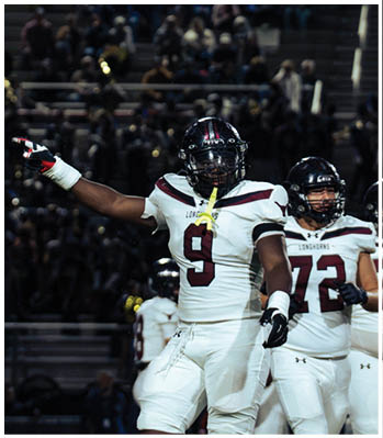 A group of football players celebrating a touchdown. Description generated by AI