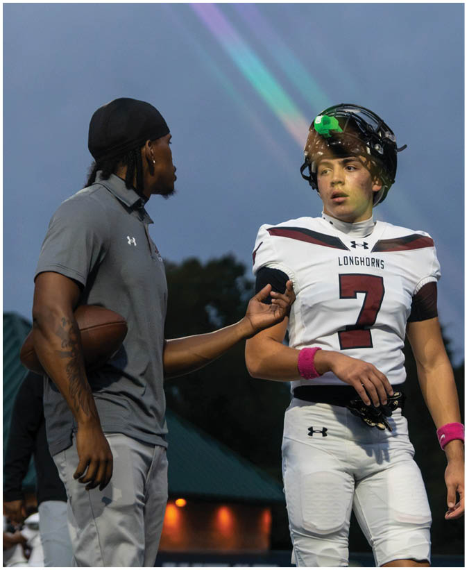 A group of football players on a field. Description generated by AI