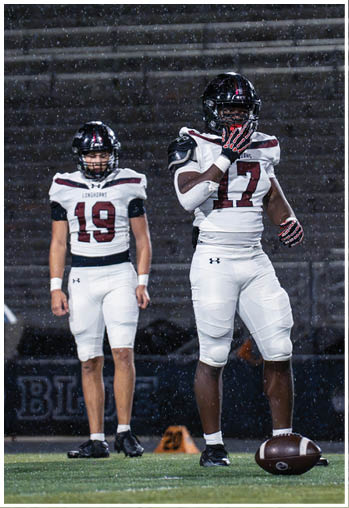 A group of football players celebrating a touchdown. Description generated by AI