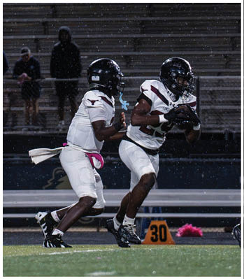 A group of football players celebrating a touchdown. Description generated by AI