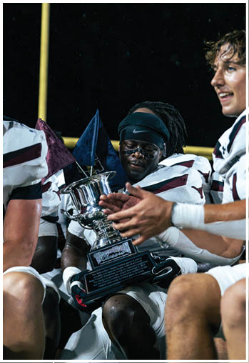 A group of football players celebrating a touchdown. Description generated by AI
