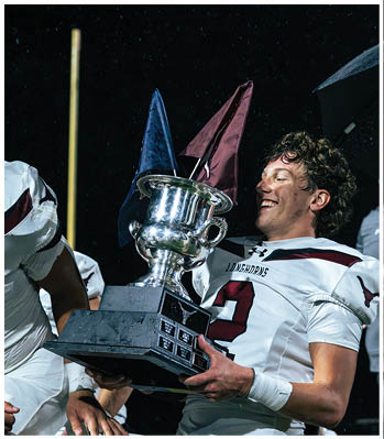 A group of football players celebrating a touchdown. Description generated by AI