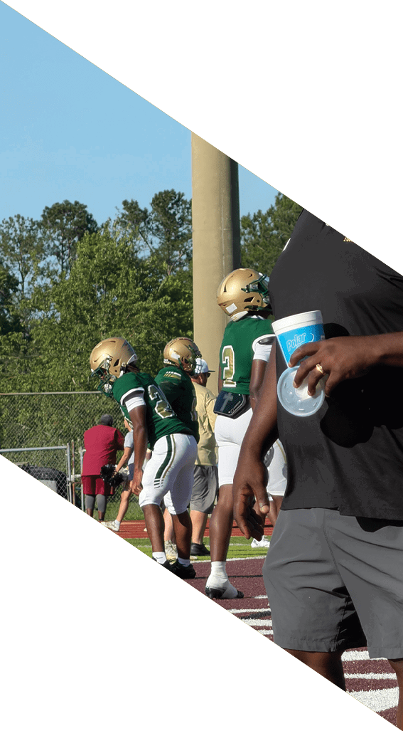 A football player wearing a black helmet and white jersey is holding a football in his hands. AI generated content