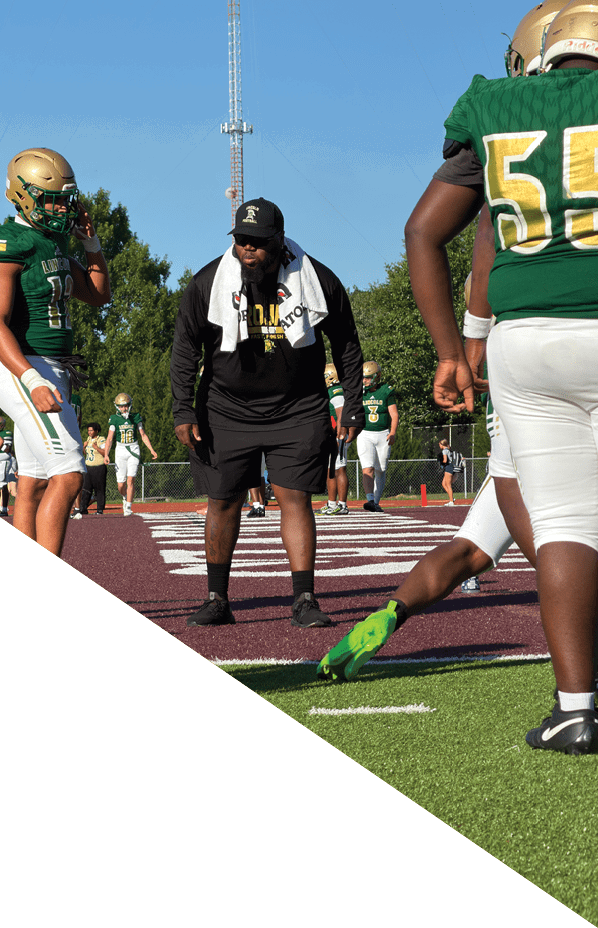 A football player is kneeling on the field, holding his helmet in his hands. AI generated content