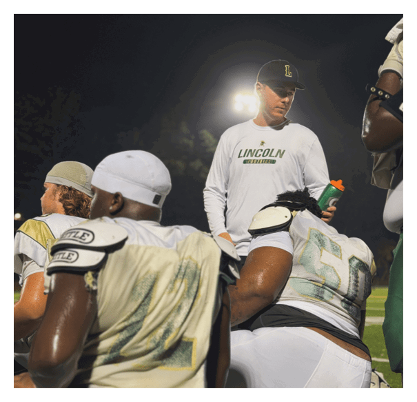 A football player is kneeling on the field, wearing a green jersey and a helmet. AI generated content